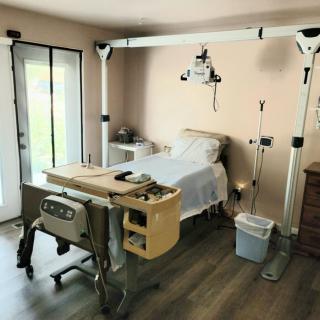A hospital room with medical equipment and a patient bed.