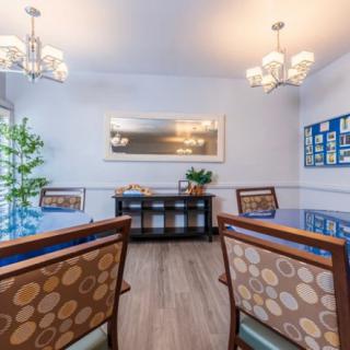 A modern dining room featuring elegant chandeliers, stylish furniture, and decorative elements.