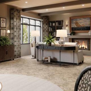 A modern living room featuring a cozy fireplace, stylish sofa, and elegant lighting.