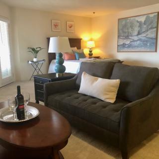 A cozy living room with a sofa, coffee table, and warm lighting.