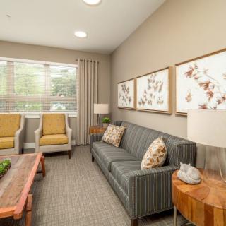 A cozy living room with contemporary furniture and decorative artwork on the walls.