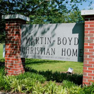 The entrance sign of the Martin-Boyd Christian Home, set amidst lush greenery.