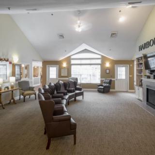 A spacious living room with comfortable seating, a fireplace, and large windows.