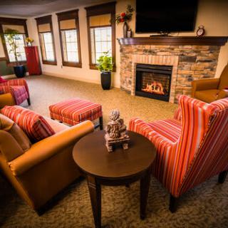 A cozy living room with comfortable seating and a fireplace.