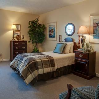 A cozy bedroom with warm lighting and classic furniture.