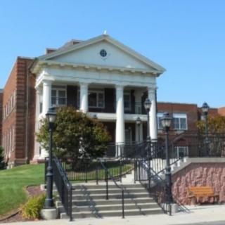 A historic building with columns and brick architecture.
