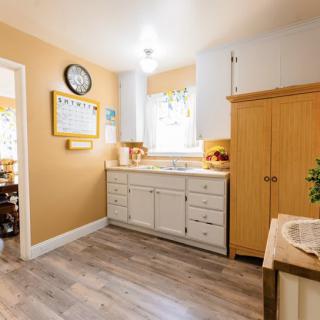 A modern kitchen with wooden cabinets and bright lighting.
