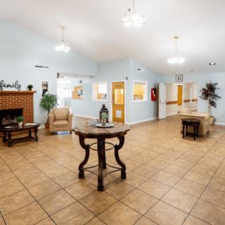 A spacious and bright lobby area with tiled floors and elegant furniture.