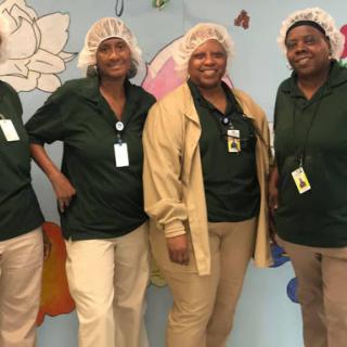 A cheerful team in their work uniforms, showcasing teamwork and camaraderie.
