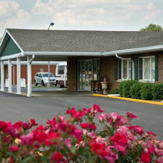 A cozy motel entrance surrounded by vibrant flowers.