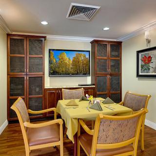 A cozy dining room with wooden furniture and decorative artwork on the walls.