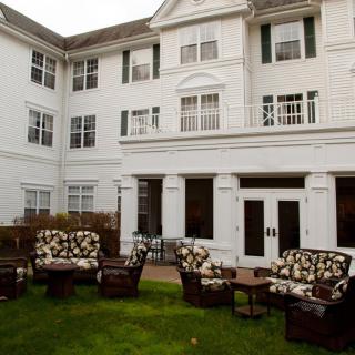 A residential building with outdoor seating and patio furniture.