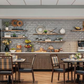 A modern kitchen and dining area adorned with decorative shelves and wooden furniture.