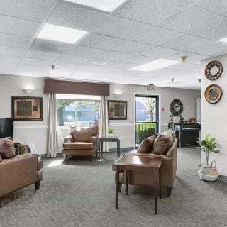 A cozy, well-lit living room with comfortable seating and decorative elements.