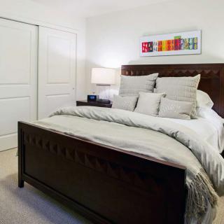 A cozy, well-decorated bedroom with a large bed and modern decor.