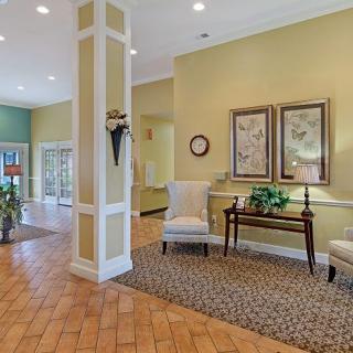 A warmly decorated lobby featuring seating and artwork.