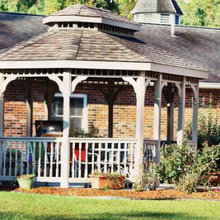 A charming gazebo surrounded by lush greenery, perfect for outdoor gatherings.