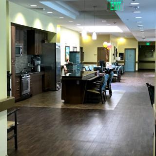 A view of a spacious and modern kitchen-dining area designed for community gatherings.