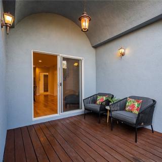 A cozy patio with modern outdoor seating and warm lighting.