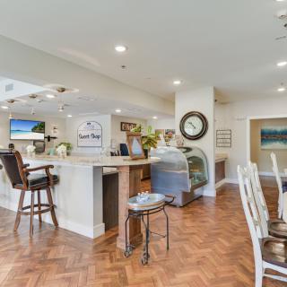 A cozy cafe interior with a seating area, counter, and decorative elements.