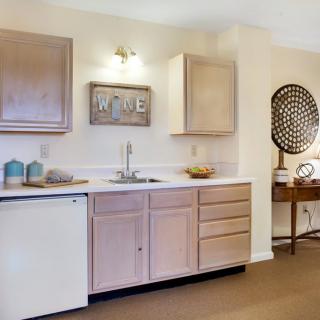 A cozy kitchen space with wooden cabinets and stylish decor.