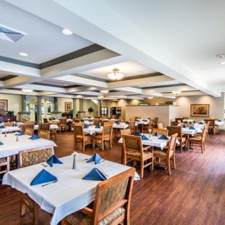 An elegant restaurant dining area with neatly set tables and chairs.