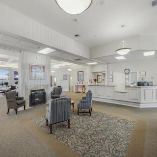 A bright and inviting lobby with comfortable seating and a reception desk.