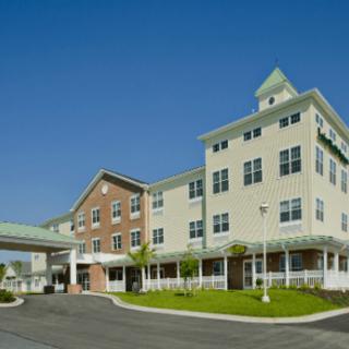 A modern senior living facility with a welcoming entrance and well-maintained grounds.