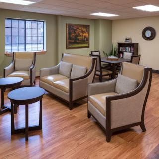 A cozy waiting area featuring comfortable sofas and chairs, perfect for relaxation.