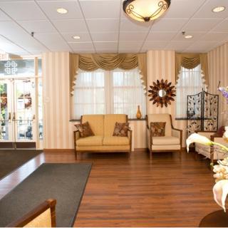 A cozy lobby with seating area, wooden floors, and decorative elements.