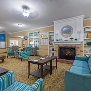 A cozy living room with comfortable seating around a fireplace.