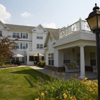 A residential building with a well-maintained garden and outdoor seating area.