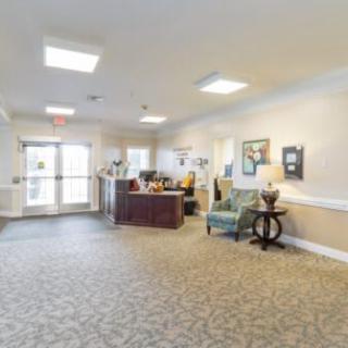 A well-lit lobby with a reception desk and comfortable seating.