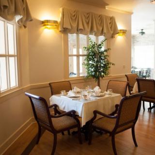An elegant dining area with a neatly set table and classic decor.