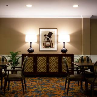 A cozy seating area with elegant lamps and artwork on the wall.