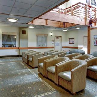 Spacious waiting room with comfortable seating and natural lighting.