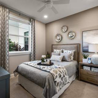 A cozy bedroom with stylish decor and a comfortable bed.
