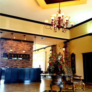 Elegant lobby area with chandelier, reception desk, and decorative elements.