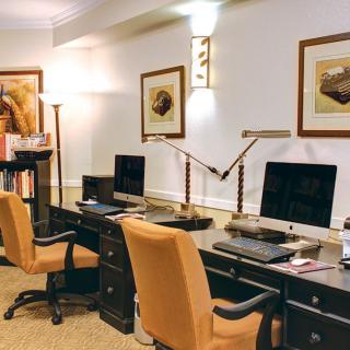 A neatly organized office space with workstations, computers, and comfortable chairs.