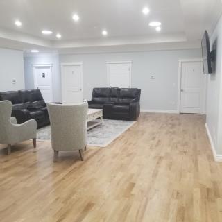 A modern living room with comfortable seating and a large television.