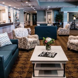 A modern and inviting lobby seating area with comfortable chairs and a coffee table.