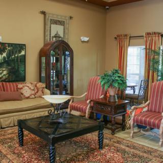 A cozy living room with elegant furniture and decorative elements.