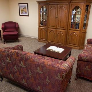 A cozy living room with a sofa set and wooden cabinet.