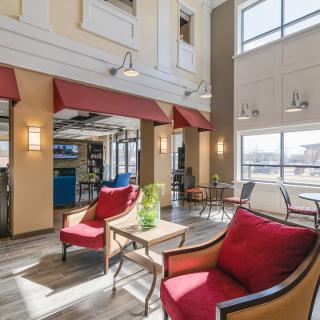 A modern lobby seating area with natural light streaming through large windows.
