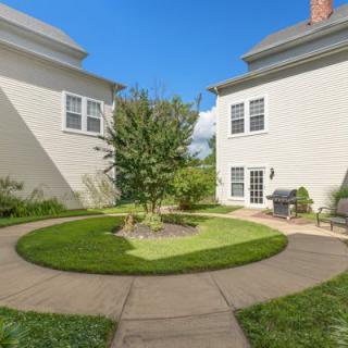 A landscaped courtyard with a circular walkway between two buildings.