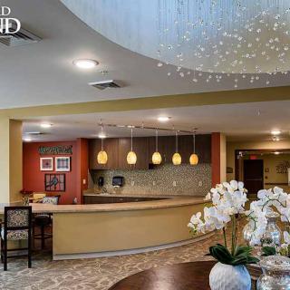 A modern lobby with a reception desk and elegant lighting.
