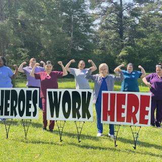 Healthcare professionals proudly celebrating their dedication with a powerful message.