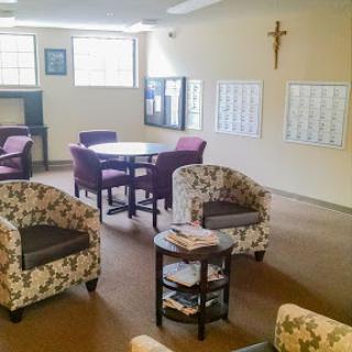 A cozy community lounge area featuring comfortable seating and a welcoming atmosphere.