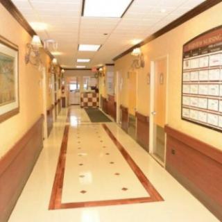 A well-lit hallway with tiled flooring and decorated walls.