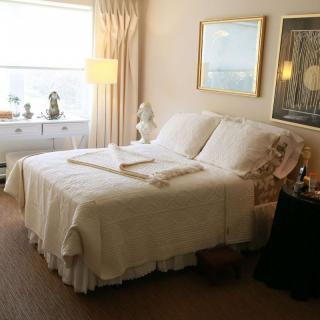 A cozy bedroom with elegant decor and soft lighting.